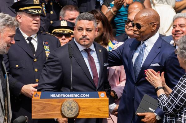 Edward A. Caban, center, speaks after being sworn in as NYPD police commissio<em></em>ner outside New York City Police Department 40th Precinct on Monday, July 17, 2023, in New York. Mayor Eric Adams on the right.