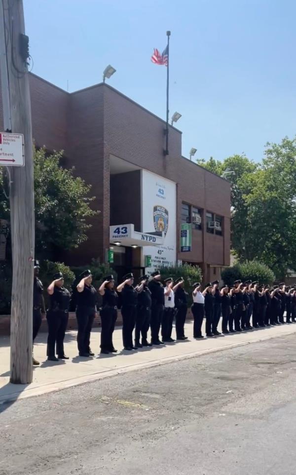 Police saluting DiMartini at his funeral procession.