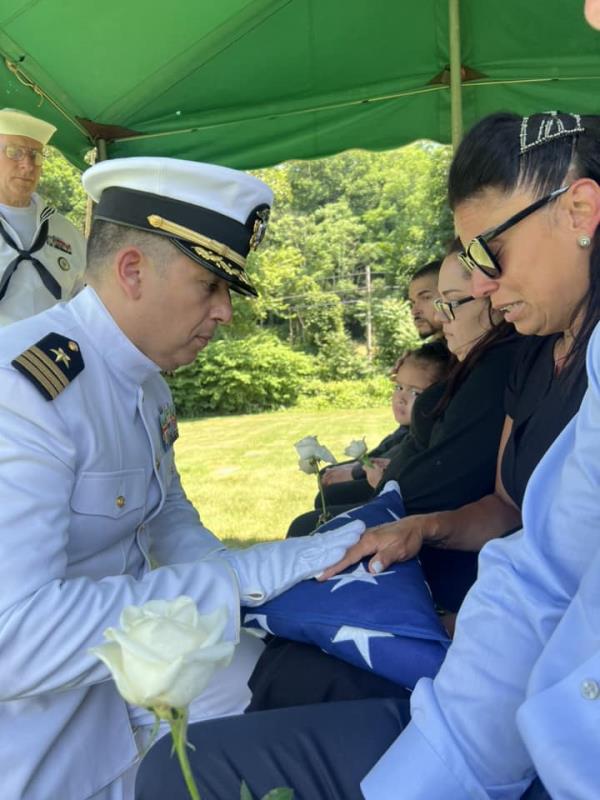 DiMartini's family members being presented the flag.