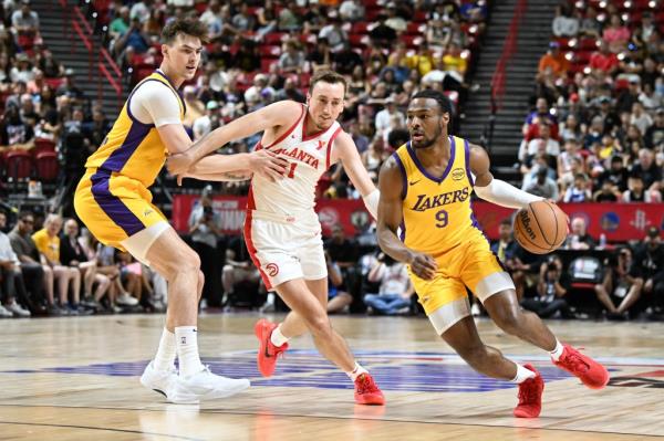 Bro<em></em>nny James Jr. #9 of the Los Angeles Lakers dribbles the ball past Moses Wood #31 of the Atlanta Hawks in the first half of a 2024 NBA Summer League game at the Thomas & Mack Center on July 17, 2024 in Las Vegas, Nevada. 