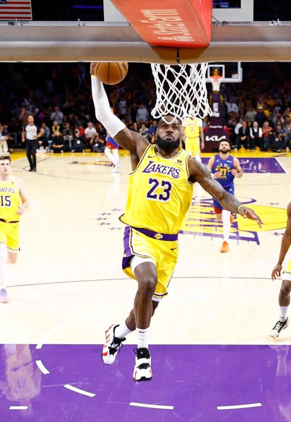 LeBron James #23 of the Los Angeles Lakers makes a slam dunk against the Denver Nuggets in the first quarter during game three of the Western Co<em></em>nference First Round Playoffs at Crypto.com Arena on April 25, 2024 in Los Angeles, California.  