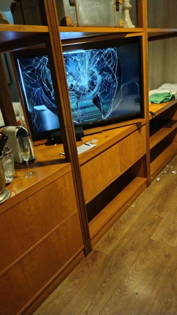 Handout photo released by the Buenos Aires Police showing a TV with a broken screen and a half-full glass of champagne at the hotel room wher<em></em>e late British musician Liam Payne was staying in Buenos Aires on October 16, 2024. 