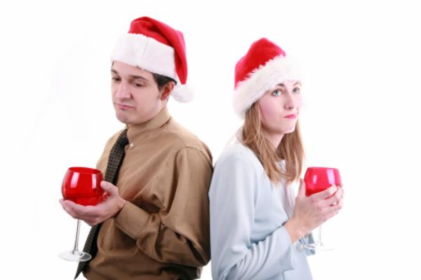 Two co-workers looking facing away from each other looking awkward at the Christmas party.