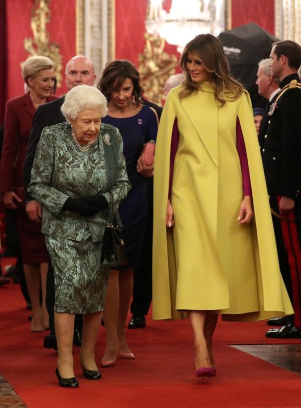 Queen Elizabeth II walking with Melania Trump and Agata Kornhauser-Duda during a NATO Alliance reception at Buckingham Palace