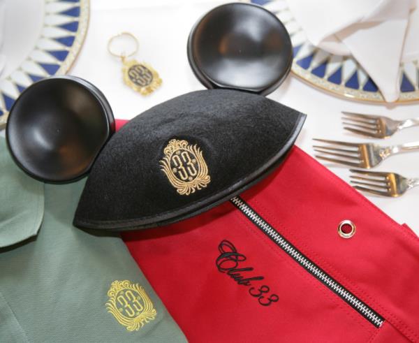 Embroidered Club 33 logo on black hat and red bag with silverware inside Disneyland restaurant in Anaheim, California