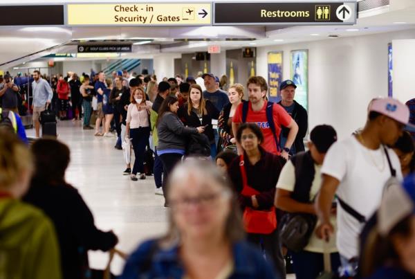 People queue for their flight reschedule.