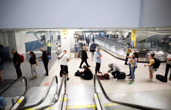 Individuals assemble and await the rescheduling of their flights.