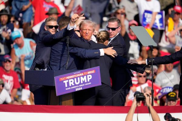 Republican presidential candidate former President Do<em></em>nald Trump is surround by U.S. Secret Service agents at a campaign event in Butler, Pa., Saturday, July 13, 2024. (AP Photo/Gene J. Puskar)