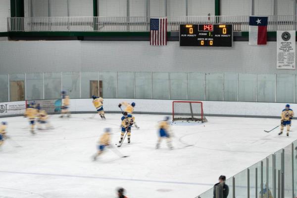 Eric Perardi's son and his team warm up before a hockey game