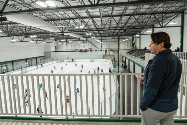 Eric Perardi watches his son's hockey game at The Crossover sports and entertainment facility in Cedar Park on Friday, Jan. 26, 2024.