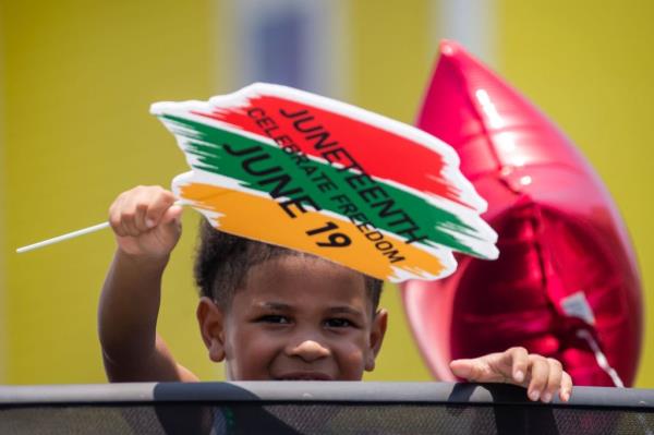 A child celebrating Juneteenth at a parade in Galveston, Texas on June 17, 2023.