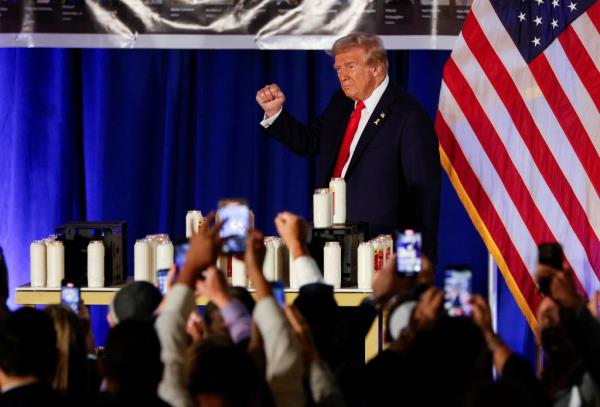 Do<em></em>nald Trump gestures as he attends an event commemorating the one-year anniversary of the October 7 Hamas attacks on Israel, at his golf resort in Doral, Florida, October 7, 2024. 