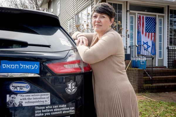 Esther Shali-Ogli standing by a car, expressing co<em></em>ncern after being laid off as principal from Juan Morel Campos Seco<em></em>ndary School due to her support for Israel.