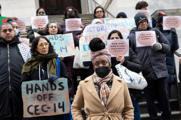 A group of parents, educators, and supporters holding signs at a rally outside the Department of Education offices in Manhattan for protection against discrimination for supporting Palestine.