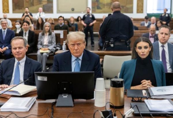 Former President Do<em></em>nald Trump sits in the courtroom with his legal team before the co<em></em>ntinuation of his civil business fraud trial at New York Supreme Court, Wednesday, Oct. 18, 2023, in New York. (Jeenah Moon/Pool Photo via AP)