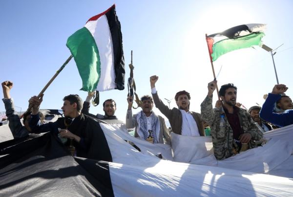 Palestinians in the streets with flags. 