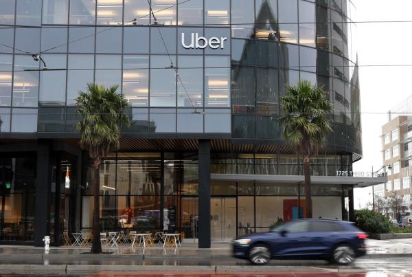 A car driving past Uber headquarters in San Francisco.