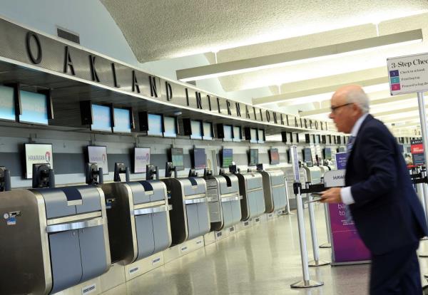 Traveler walking through Terminal 1 at Oakland Internatio<em></em>nal Airport, California on April 12, 2024