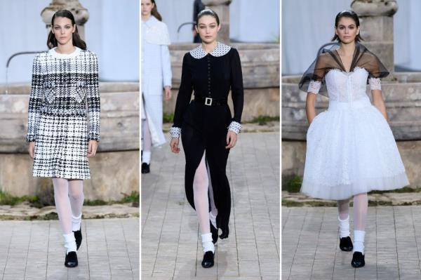 Three models at Chanel's 2020 spring couture show include Vittoria Ceretti, Gigi Hadid, and Kaia Gerber. Each model wears white tights.