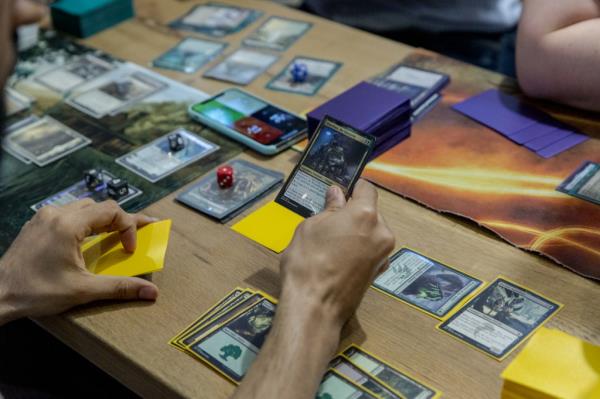 Participants engaging in a Magic: The Gathering card game tournament at Uncommons hobby shop in New York, 2019