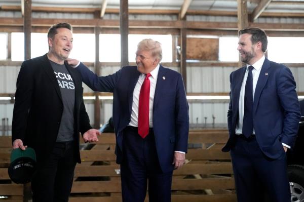 Elon Musk, Do<em></em>nald Trump, and Sen. JD Vance in suits at a campaign event for the 2024 Presidential Election