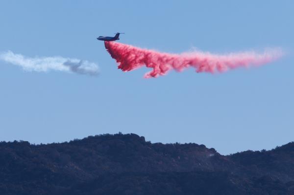 Plane drops fire retardant