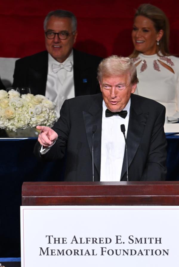 Do<em></em>nald Trump in a tuxedo giving a speech at the 2024 Al Smith Dinner, with an audience of notable figures like Martha MacCallum and others present.