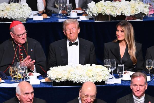 Do<em></em>nald Trump, Melania Trump, and other guests seated at a table at the 2024 Al Smith Memorial Foundation Dinner benefiting women and children in need.