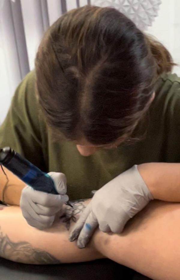 Natalie tattooing a customer