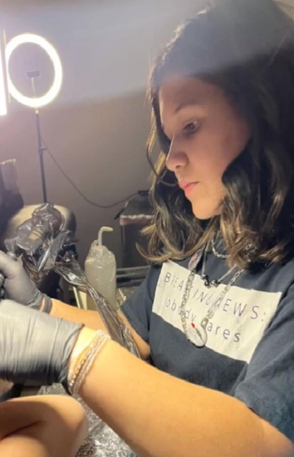 Natalie tattooing a customer