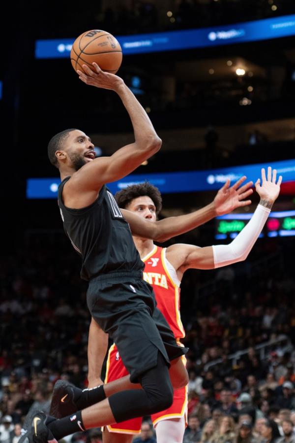 Brooklyn Nets forward Mikal Bridges scores against Atlanta Hawks forward Jalen Johnson during the first half of an NBA basketball game Wednesday, Nov. 22, 2023, in Atlanta.