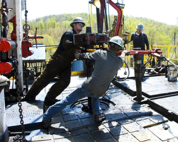 Workers moving a section of well casing at a Chesapeake Energy natural gas well site near Burlington, Pennsylvania in 2010