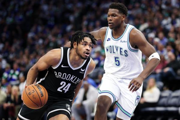 Nets guard Cam Thomas (24) works around Minnesota Timberwolves guard Anthony Edwards (5) during the second half at Target Center.