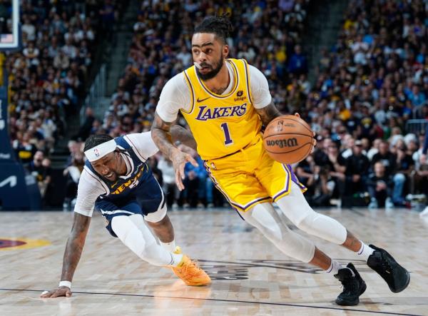 Los Angeles Lakers guard D'Angelo Russell (1) drives past Denver Nuggets guard Kentavious Caldwell-Pope in the second half of Game 5 of an NBA basketball first-round playoff series Monday, April 29, 2024, in Denver.