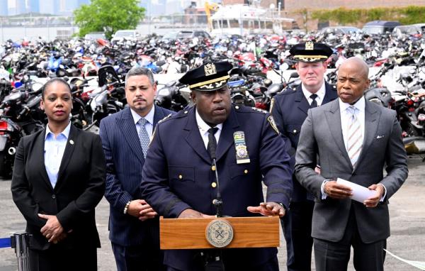 NYPD Chief of Patrol Jeffrey Maddrey speaking at a podium during the demolition of illegal ATVs and dirt bikes, with NYC mayor Eric Adams and other officials present