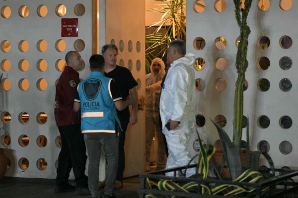 Forensic workers and police officers at the hotel.