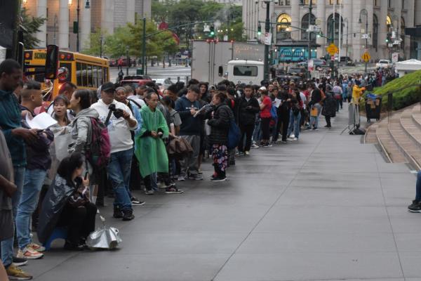 Migrants line up outside the Jacob K. Javits Federal Building in Manhattan. 