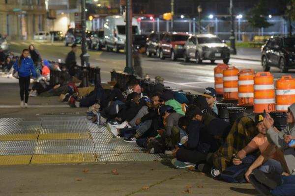 Migrants sleep outside the Jacob K. Javits Federal Building on Thursday. 