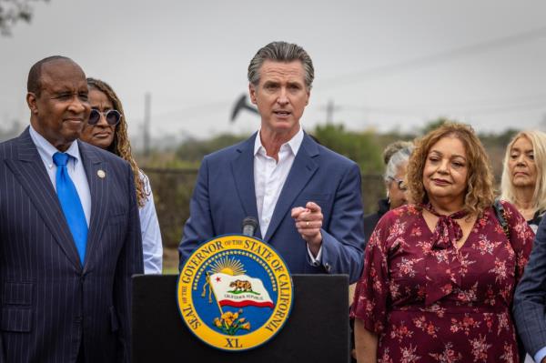 Gavin Newsom speaking at a podium.