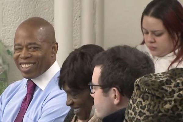 Adams flashes a smirk while attending Thursday night's meeting in Harlem.