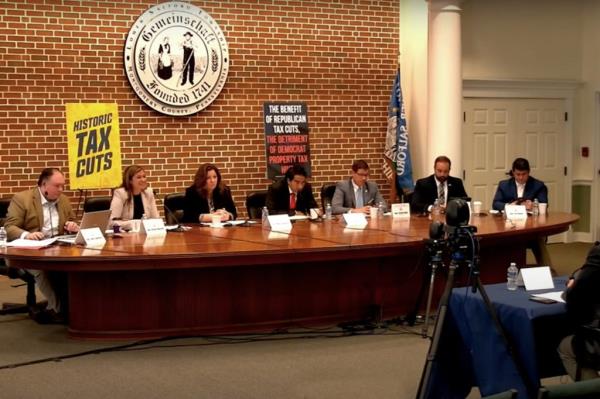 A group of people sitting at a table during a Pennsylvania House Republican Committee meeting, discussing tax burdens for constituents