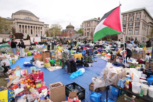 Pro-Palestinian demo<em></em>nstrators gather at an encampment on the lawn of Columbia University.