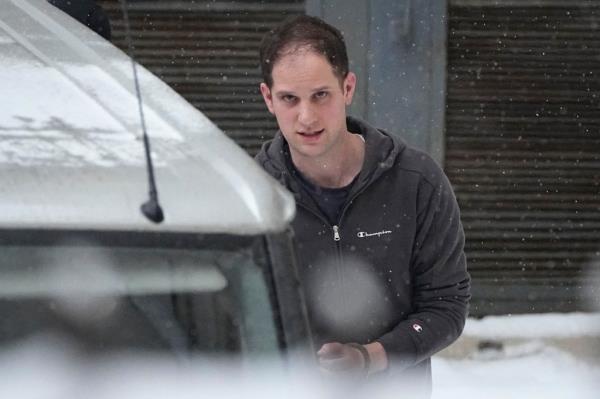 Wall Street Journal reporter Evan Gershkovich is escorted towards a prison van after exiting the Russian court in Moscow on Jan. 26, 2024.