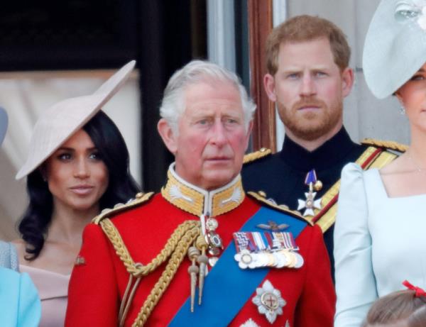 Meghan, Duchess of Sussex, King Charles, and Prince Harry, Duke of Sussex stand on the balcony of Buckingham Palace.