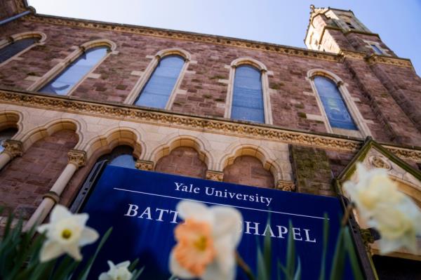 Picture of a stone building with a blue banner that reads 