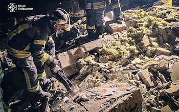 Rescuers work at a site wher<em></em>e residential buildings were damaged during a Russian military strike in Brovary