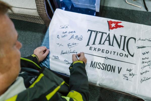 Hamish Harding shared a photo of himself signing a banner for the voyage.