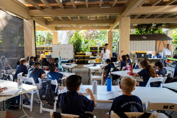 Sacred Hearts School second grade teacher Courtney Copriviza interacts with the fourth graders at their temporary school site