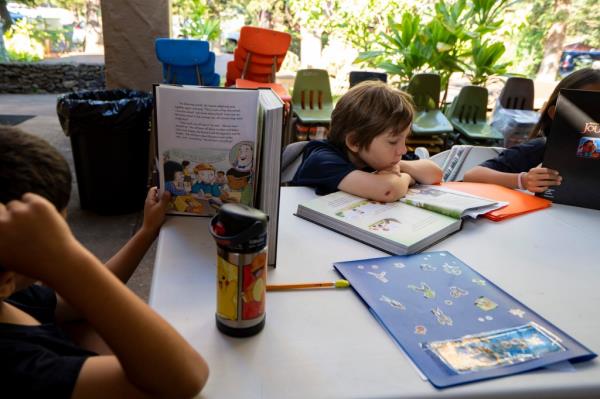 Sacred Hearts School third grade students read a book during an English language arts class at their temporary school site at Sacred Hearts Mission Church on Tuesday, Oct. 3, 2023, in Lahaina, Hawaii.