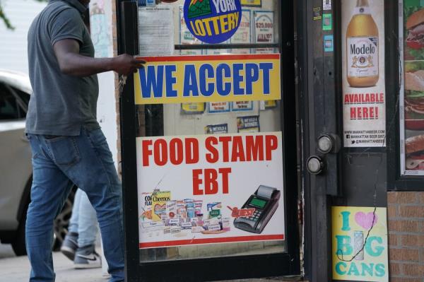 We Accept Food Stamp EBT sign in the Bronx, NY seen on Sept 19, 2019. Photo of sign with blue background and white text. No people in image.